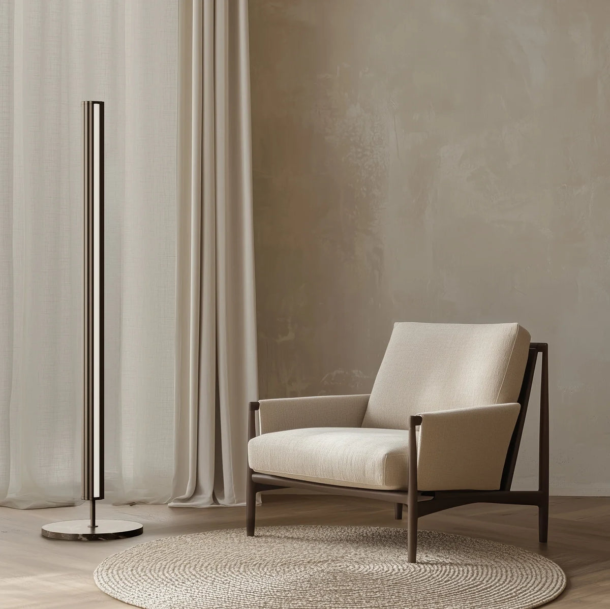 Slim LED column floor lamp with marble base, beside an armchair