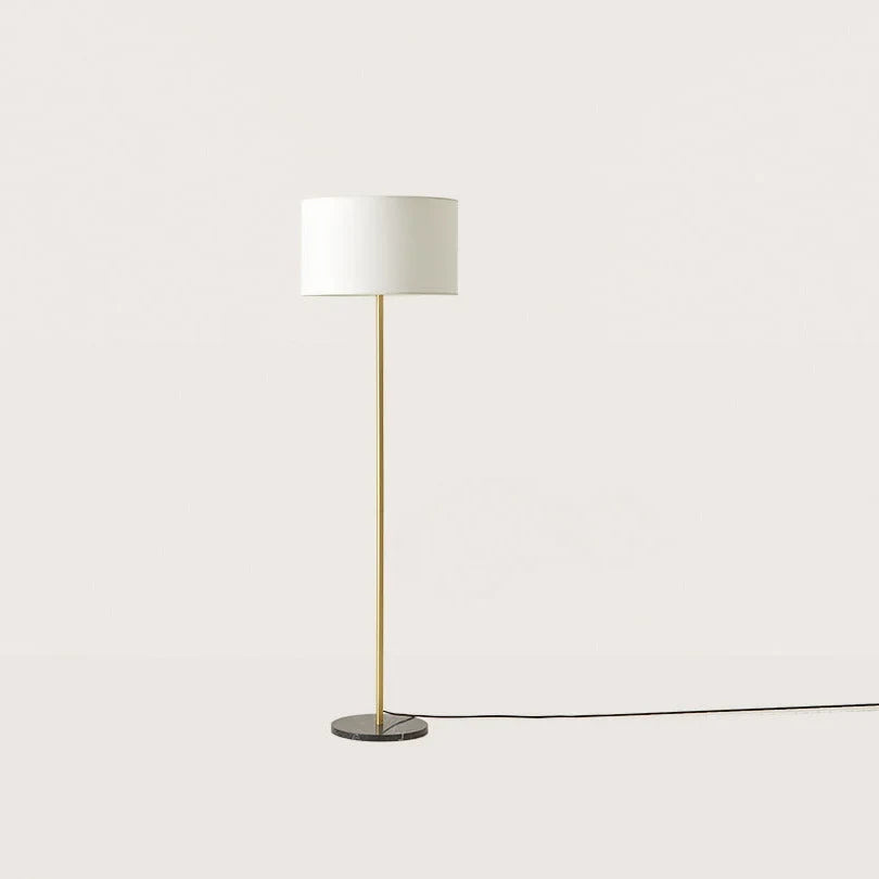 Slim column floor lamp with marble base, in matte brass, shown with a white drum shade (shade not included)