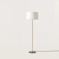 Slim column floor lamp with marble base, in matte brass, shown with a white drum shade (shade not included), second view