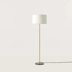 Slim column floor lamp with marble base, in matte brass, shown with a white drum shade (shade not included), second view
