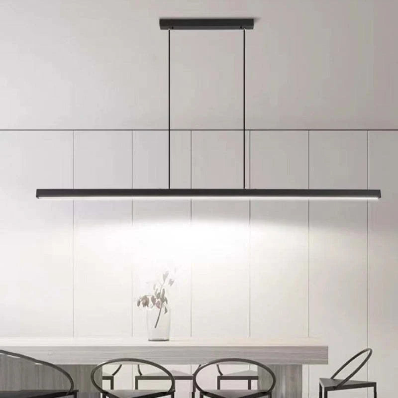 Slim linear LED pendant, over a white dining area