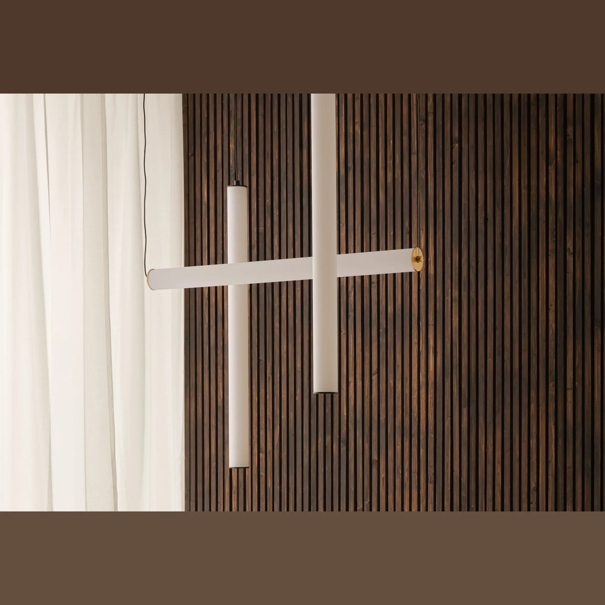 Slim linear tube LED pendant, several tubes against a wooden wall