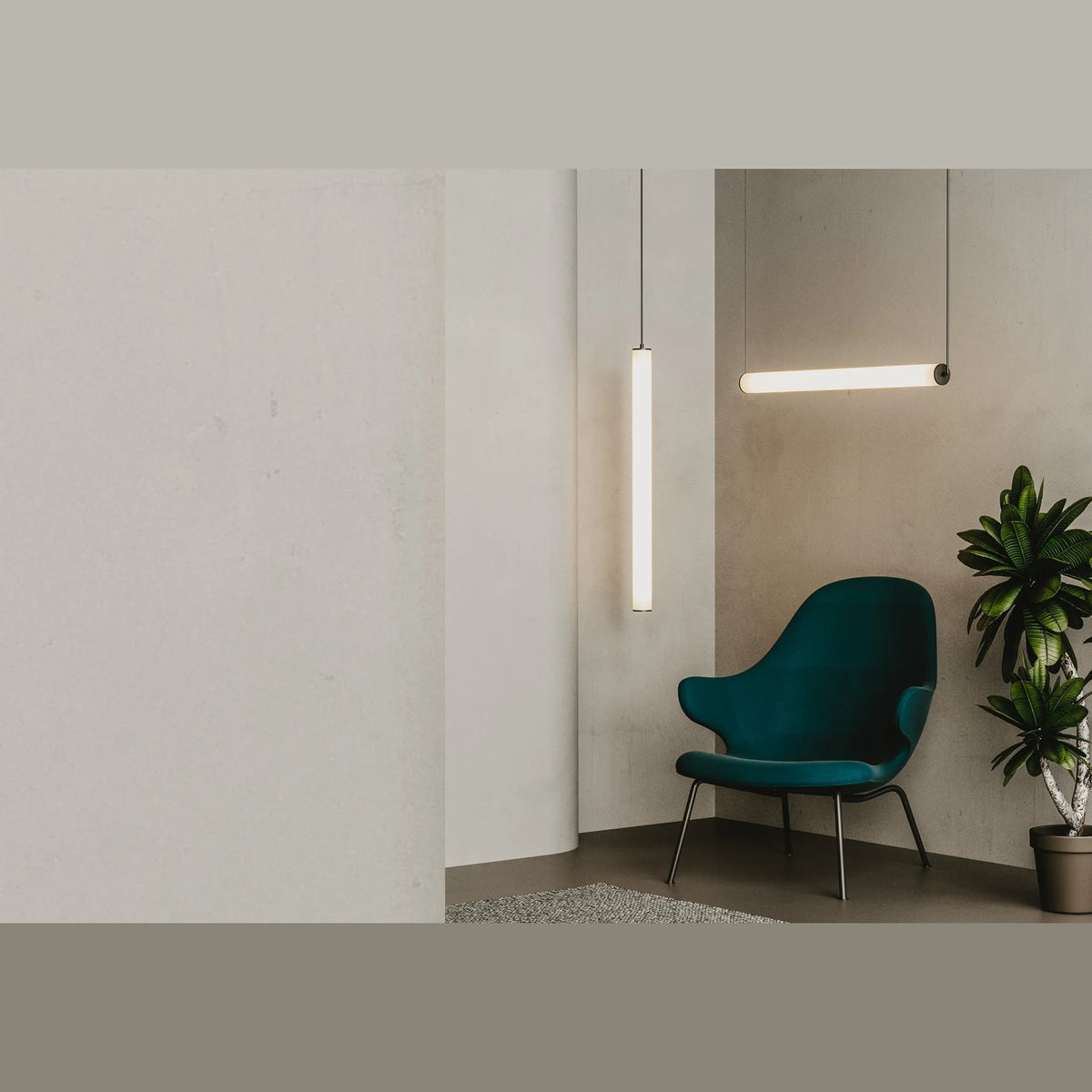 Slim linear tube LED pendant, in a room with a lounge chair