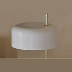 Slim stem table lamp with domed disc shade, close-up of a white shade