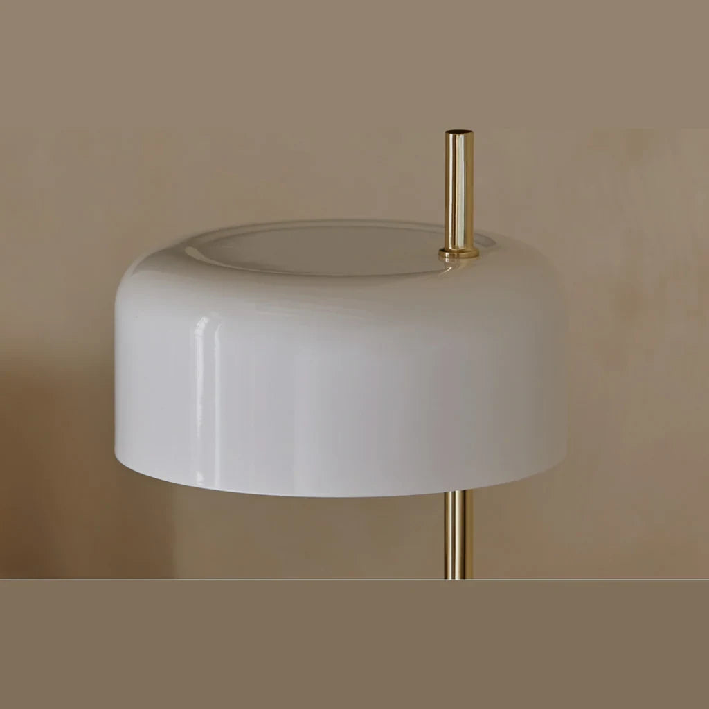 Slim stem table lamp with domed disc shade, close-up of a white shade