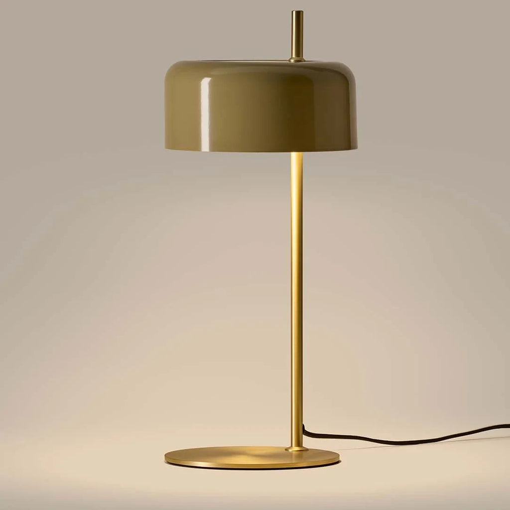 Slim stem table lamp with domed disc shade, in olive, with a brass frame, lit