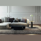 Slim stem table lamp with domed disc shade, in pale green, beside a sofa
