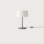 Slim stem table lamp base with black marble disc, with a black stem and a white drum shade (not included)