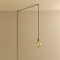 Plug-in pendant with small tinted bulb, graphite, lit, hung from a wall node