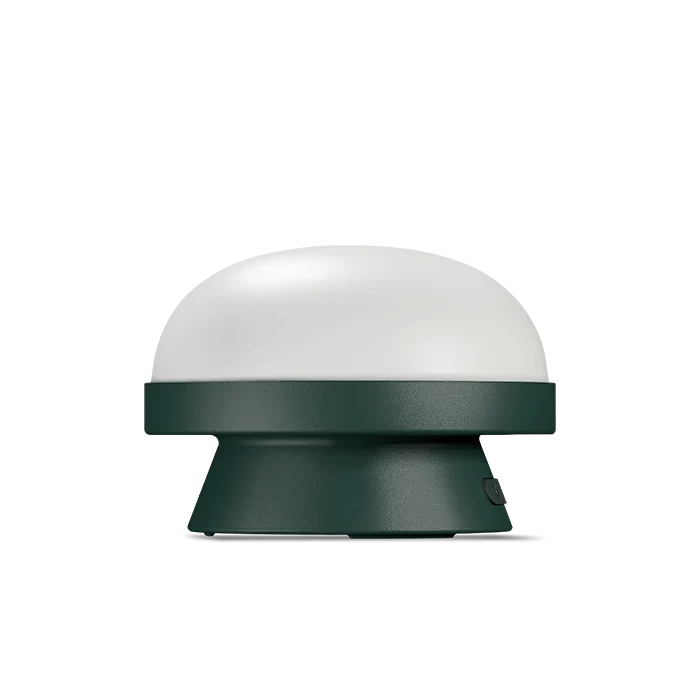 Cordless solar dome table lamp in forest green, on a white background