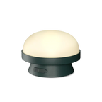 Cordless solar dome table lamp in forest green, lit on a white background