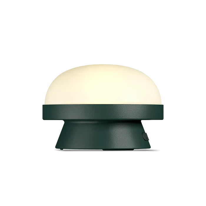 Cordless solar dome table lamp in forest green, lit, side view