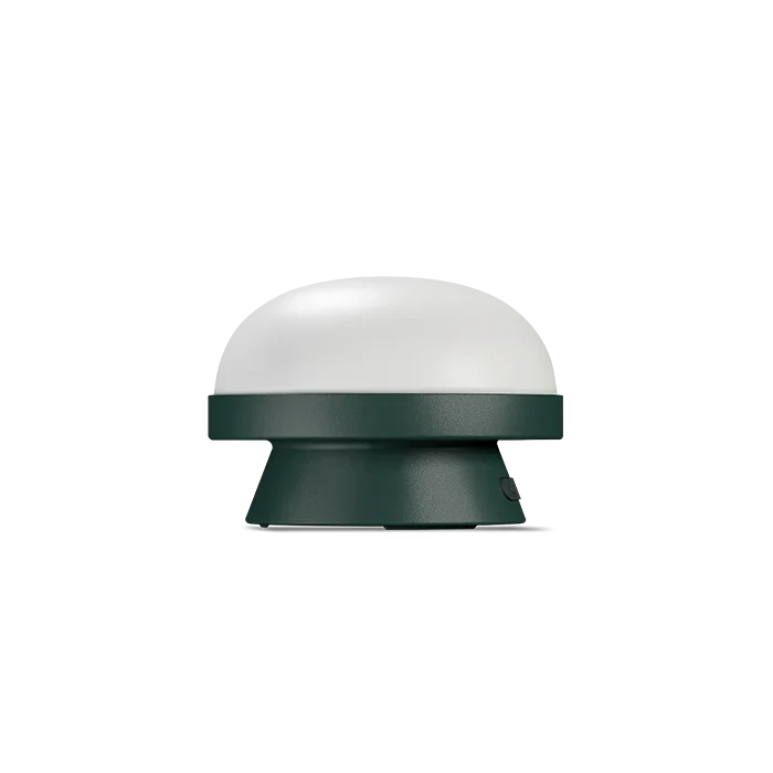 Cordless solar dome table lamp in forest green, on a white background