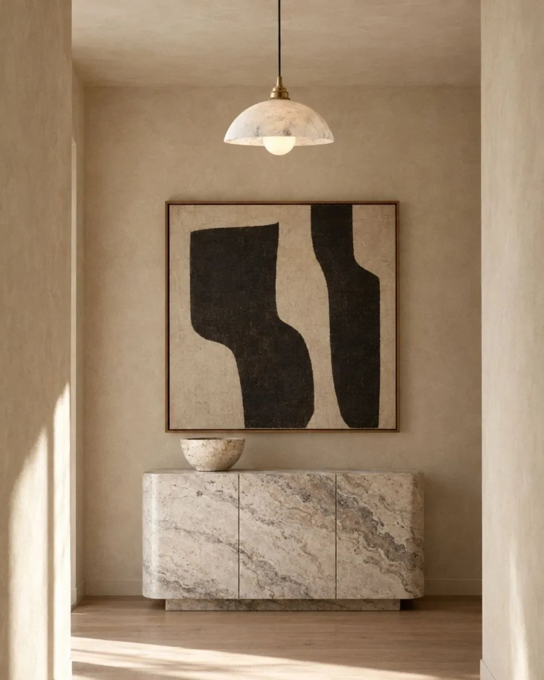 Solid marble dome pendant light, above a stone sideboard