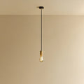 Squirrel Cage Filament Bulb Pendant, in oak, lit, against a plain wall
