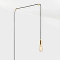 Squirrel cage filament plug-in pendant, in brass, routed across the ceiling and down the wall