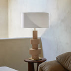 Stacked ribbed ceramic lamp, on a side table, with a shade (not included)