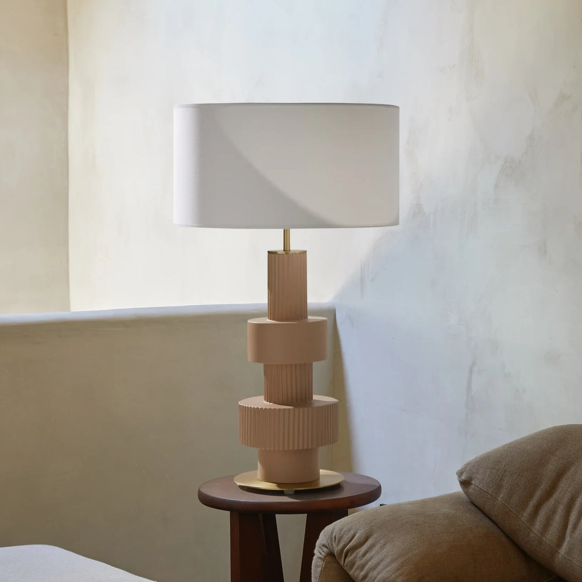 Stacked ribbed ceramic lamp, on a side table, with a shade (not included)