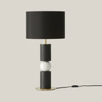 Stacked wood and marble sphere table lamp base, in black and white, shown with a black shade (sold separately)