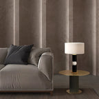 Stacked wood and marble sphere table lamp base, lit beside a sofa, with a shade (sold separately)