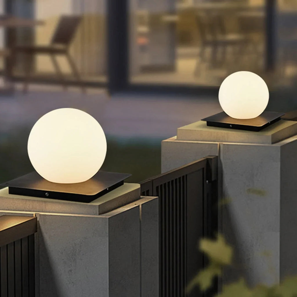 Outdoor pillar light, globe shades lit on gate pillars