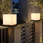 Outdoor pillar light, cube shades lit on gate pillars at night