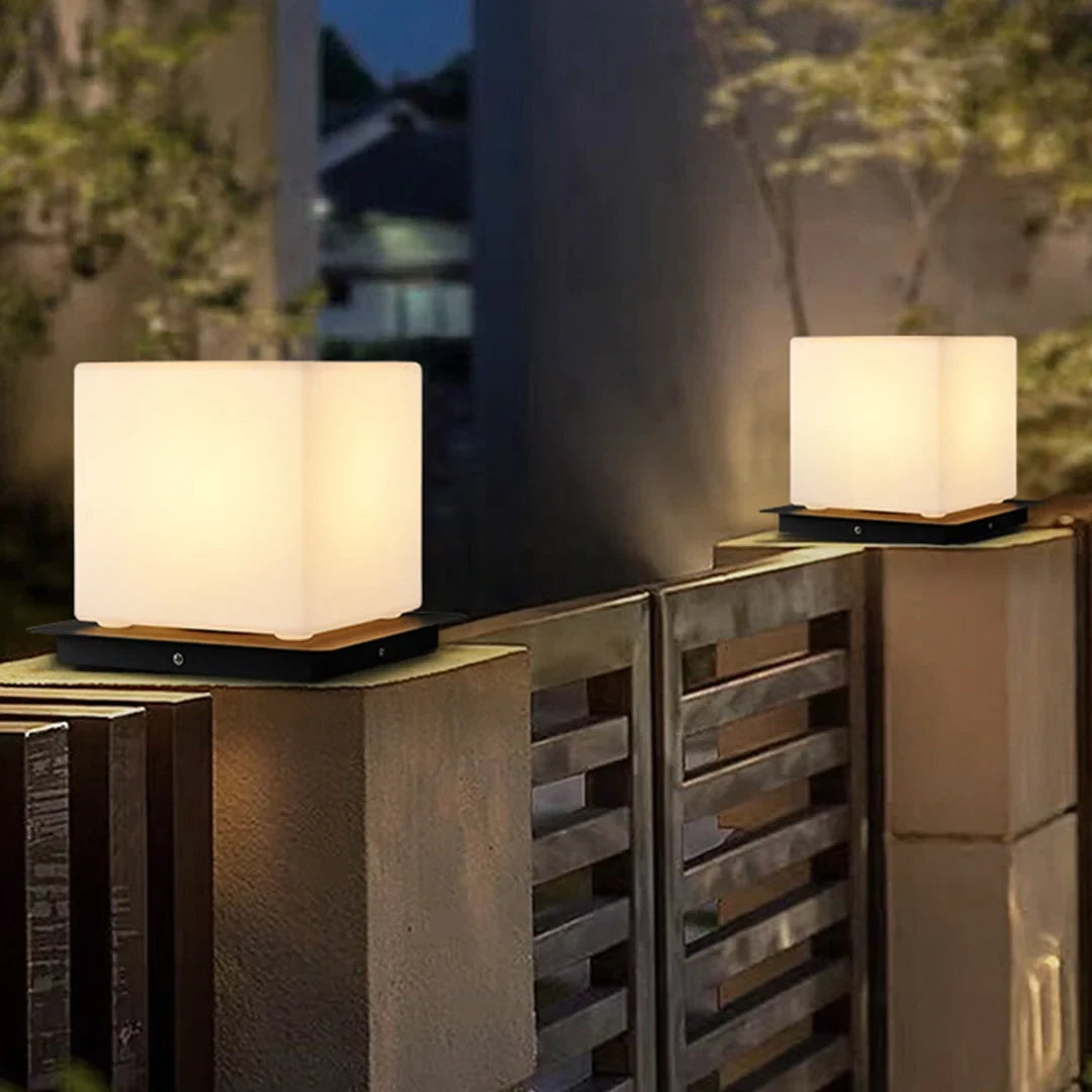 Outdoor pillar light, cube shades lit on gate pillars at night