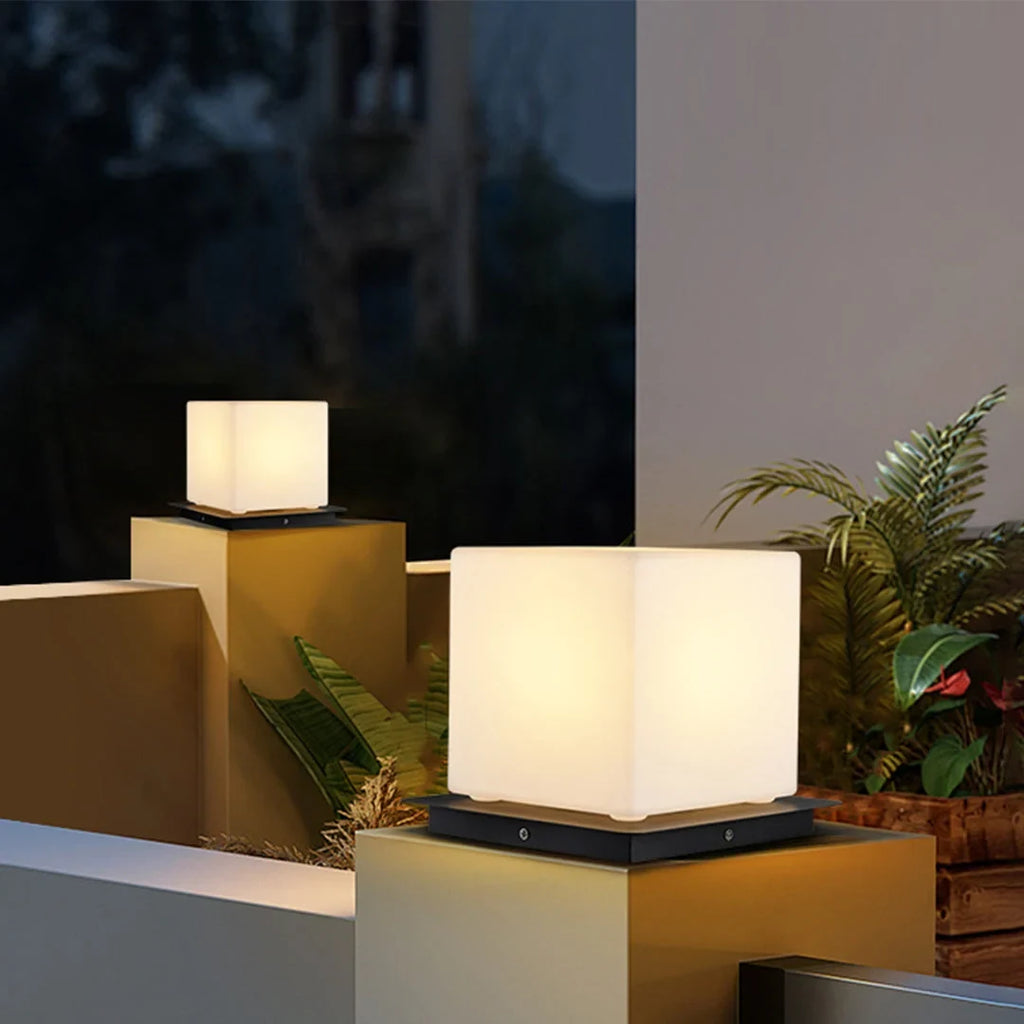 Outdoor pillar light, cube shades lit on garden walls