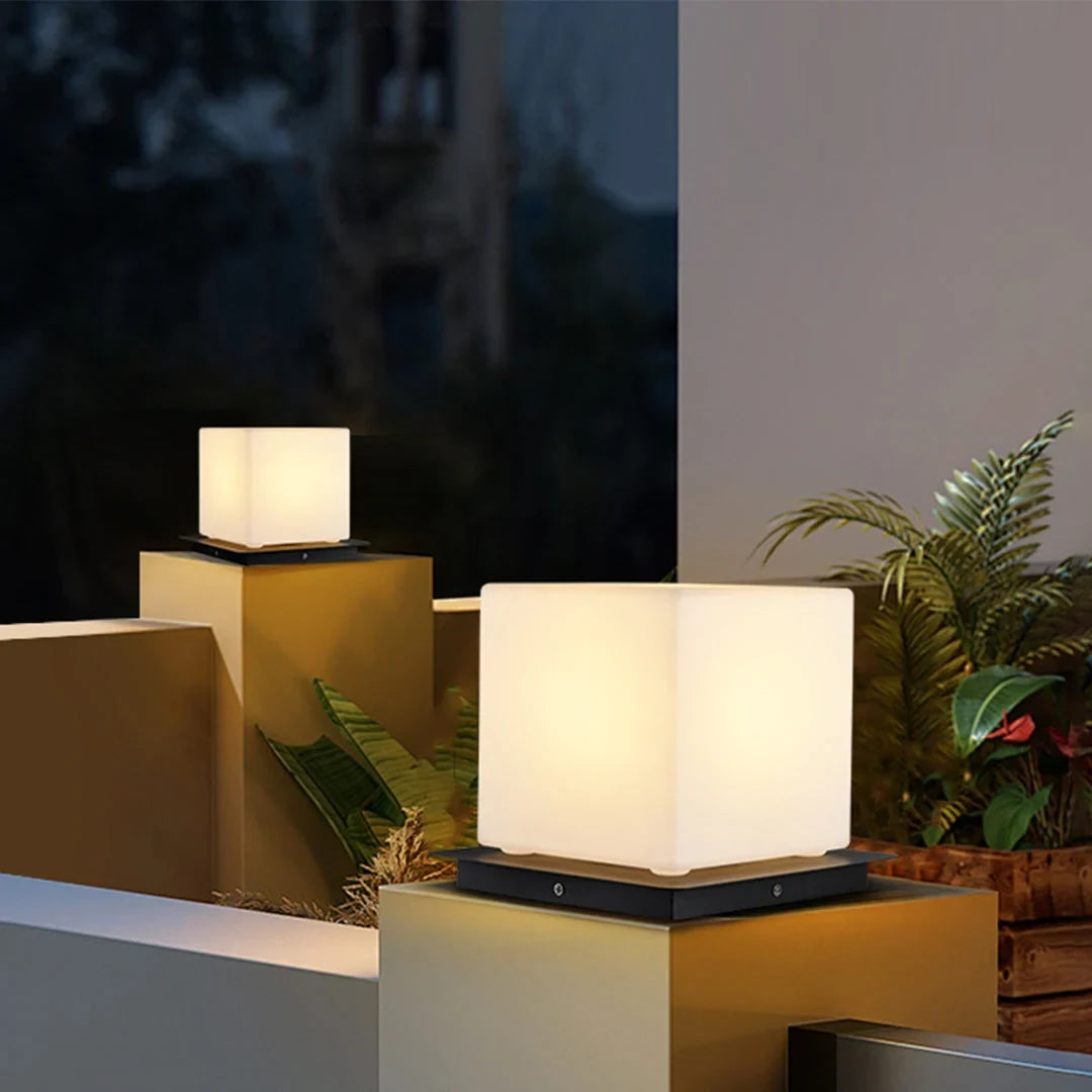 Outdoor pillar light, cube shades lit on garden walls