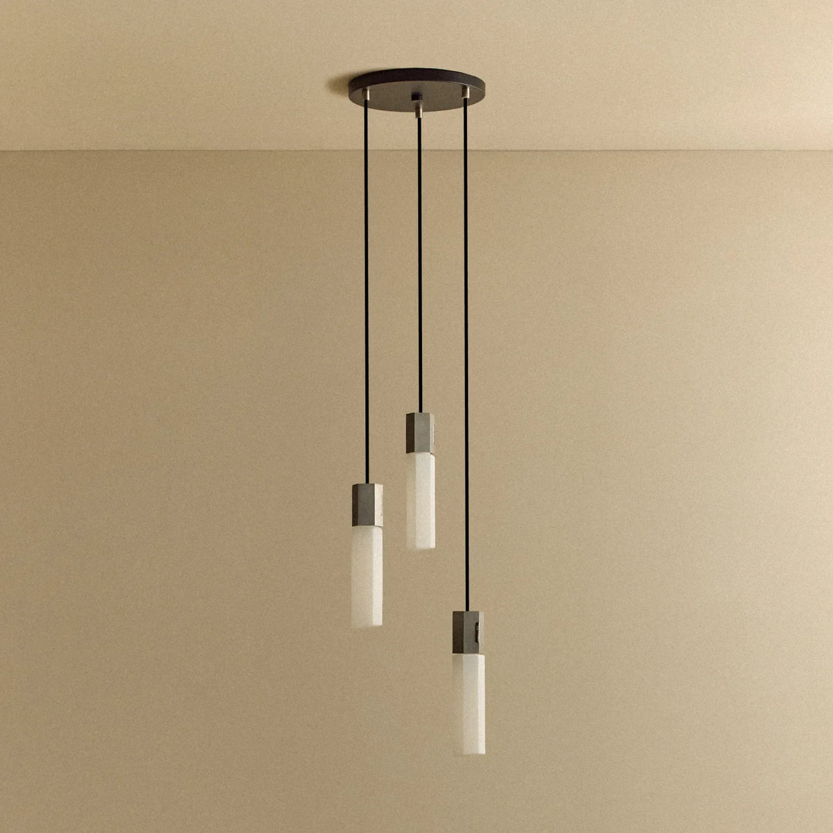 Three-drop cluster pendant in cast stainless steel with glass bulbs, unlit