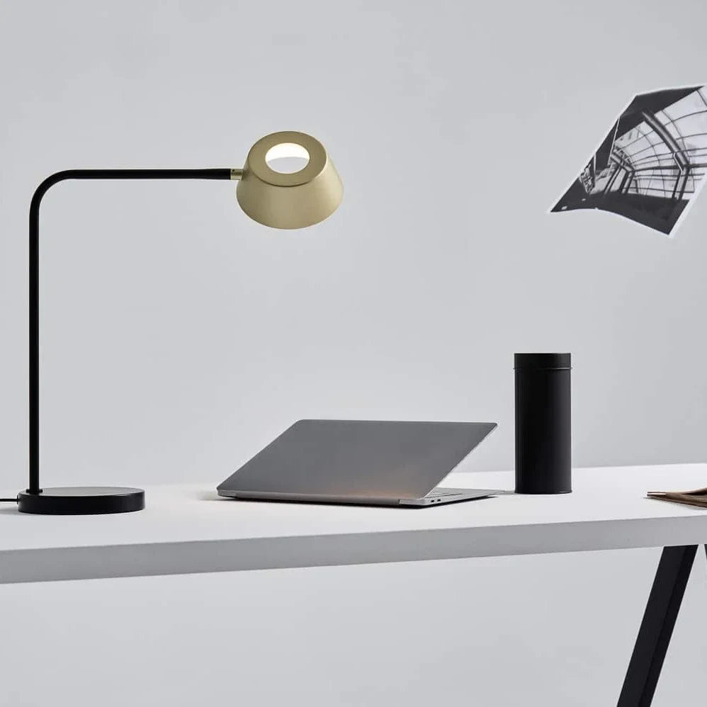 Slim desk table lamp with rotating shade, on a desk beside a laptop