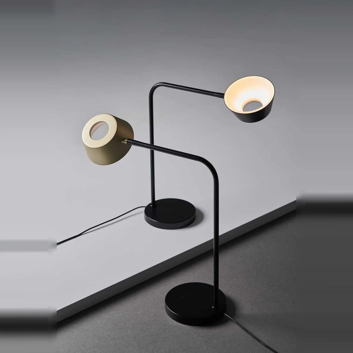 Slim desk table lamp with rotating shade, two lamps with shades turned in different directions