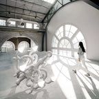 Tangled arm XL floor chandelier, in white in a large hall with a person for scale