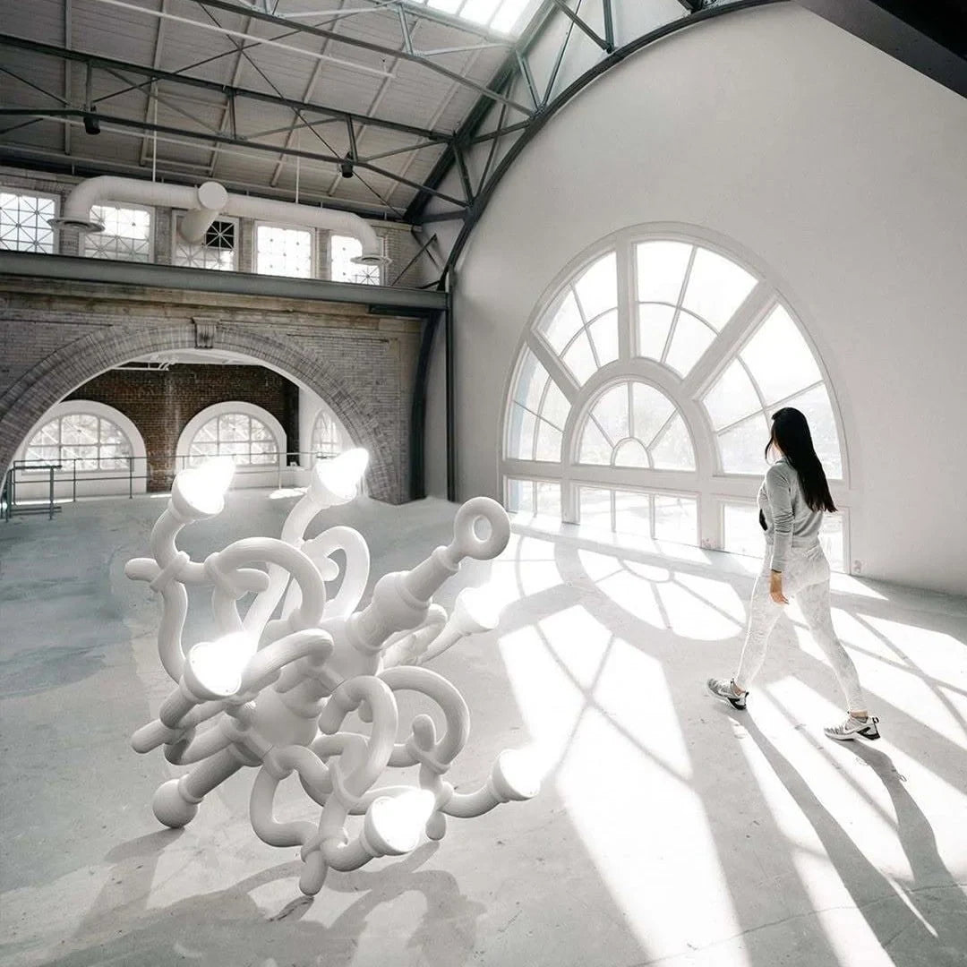 Tangled arm XL floor chandelier, in white in a large hall with a person for scale