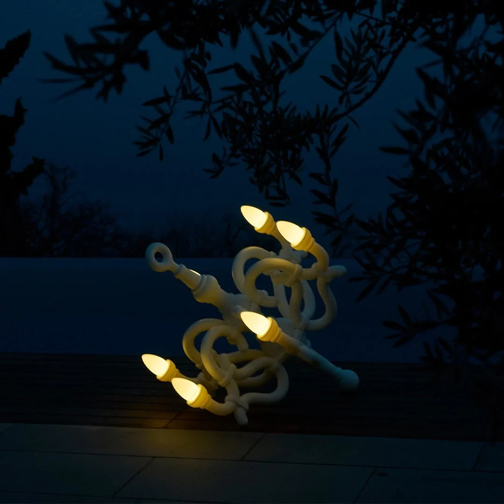 Tangled arm XL floor chandelier, lit under trees at night