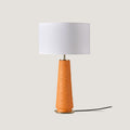 Tapered ceramic column table lamp, in orange, with a white drum shade (not included)