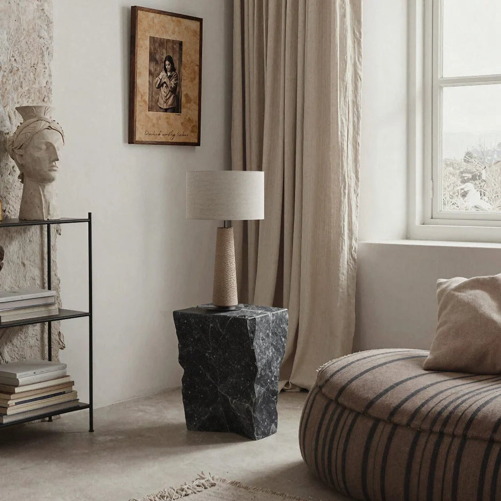 Tapered ceramic column table lamp, in a living room, with a shade (not included)