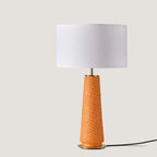 Tapered ceramic column table lamp, in orange, with a white shade (not included)