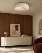 Textured pebble flush ceiling light, in white, in a living room