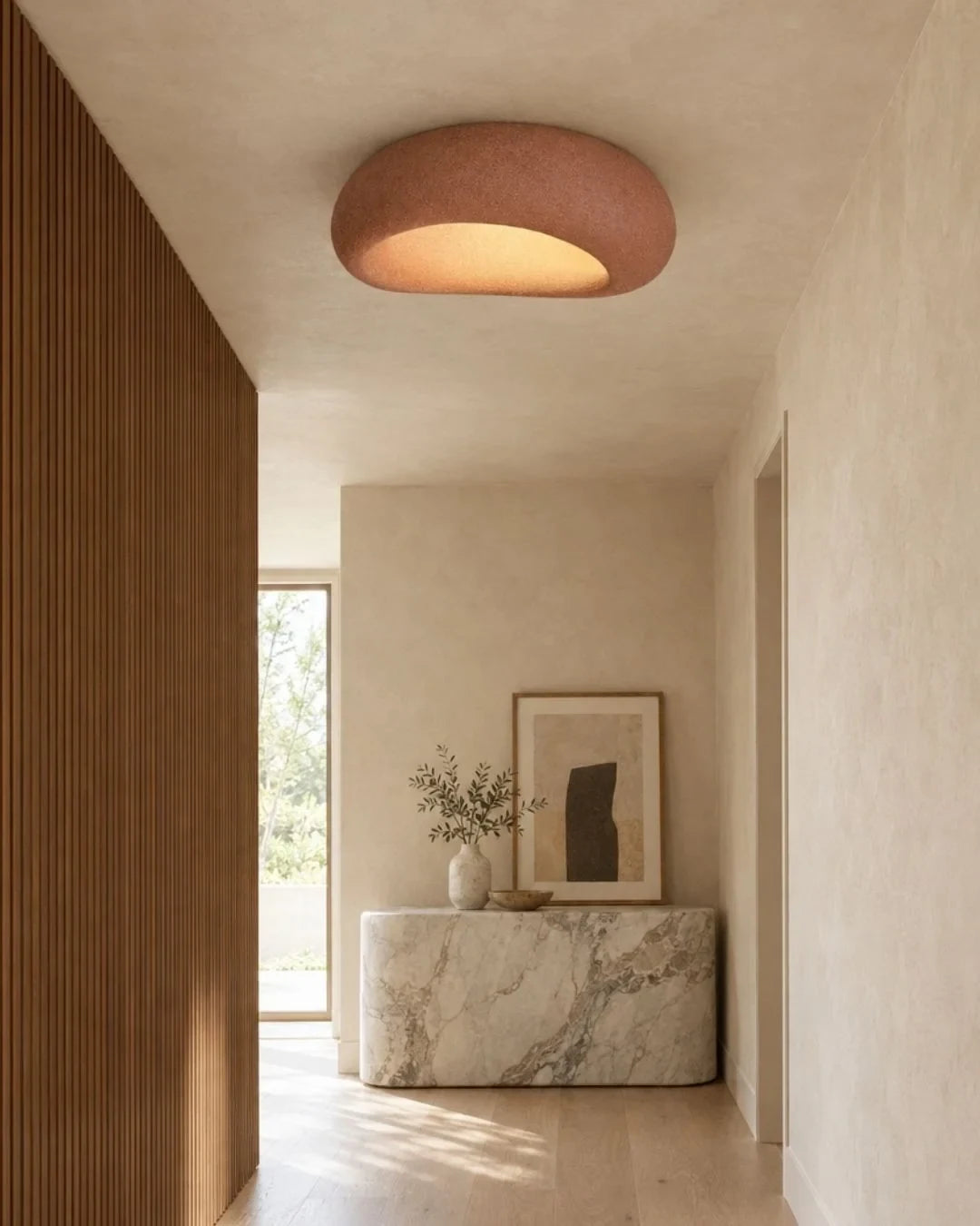 Textured pebble flush ceiling light, in red, in a hallway