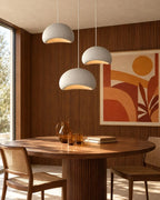 Textured sculptural pendant light, three above a dining table