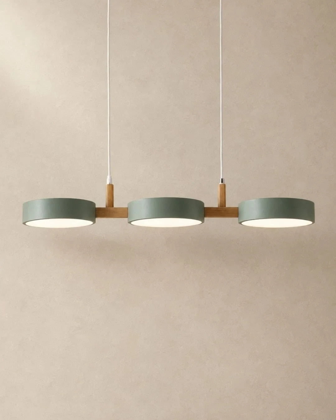 Three-light linear pendant with a wooden bar, with green shades