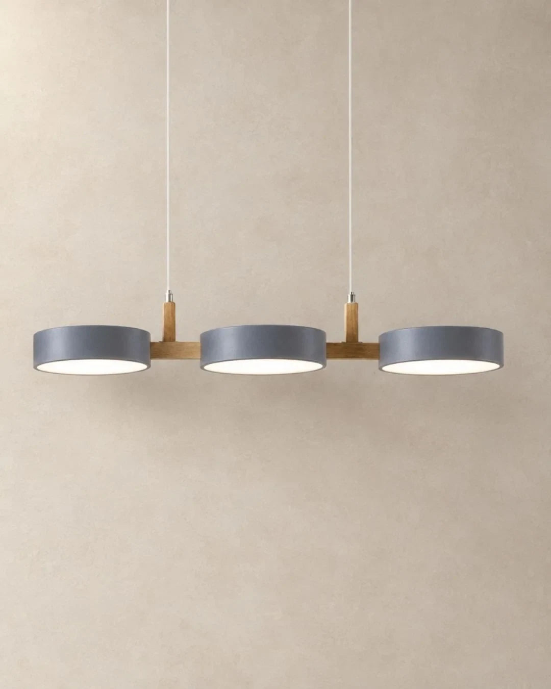 Three-light linear pendant with a wooden bar, with grey shades