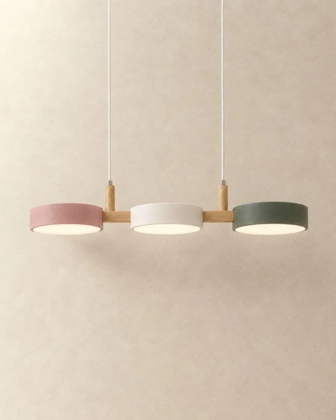 Three-light linear pendant with a wooden bar, with pink, white and green shades