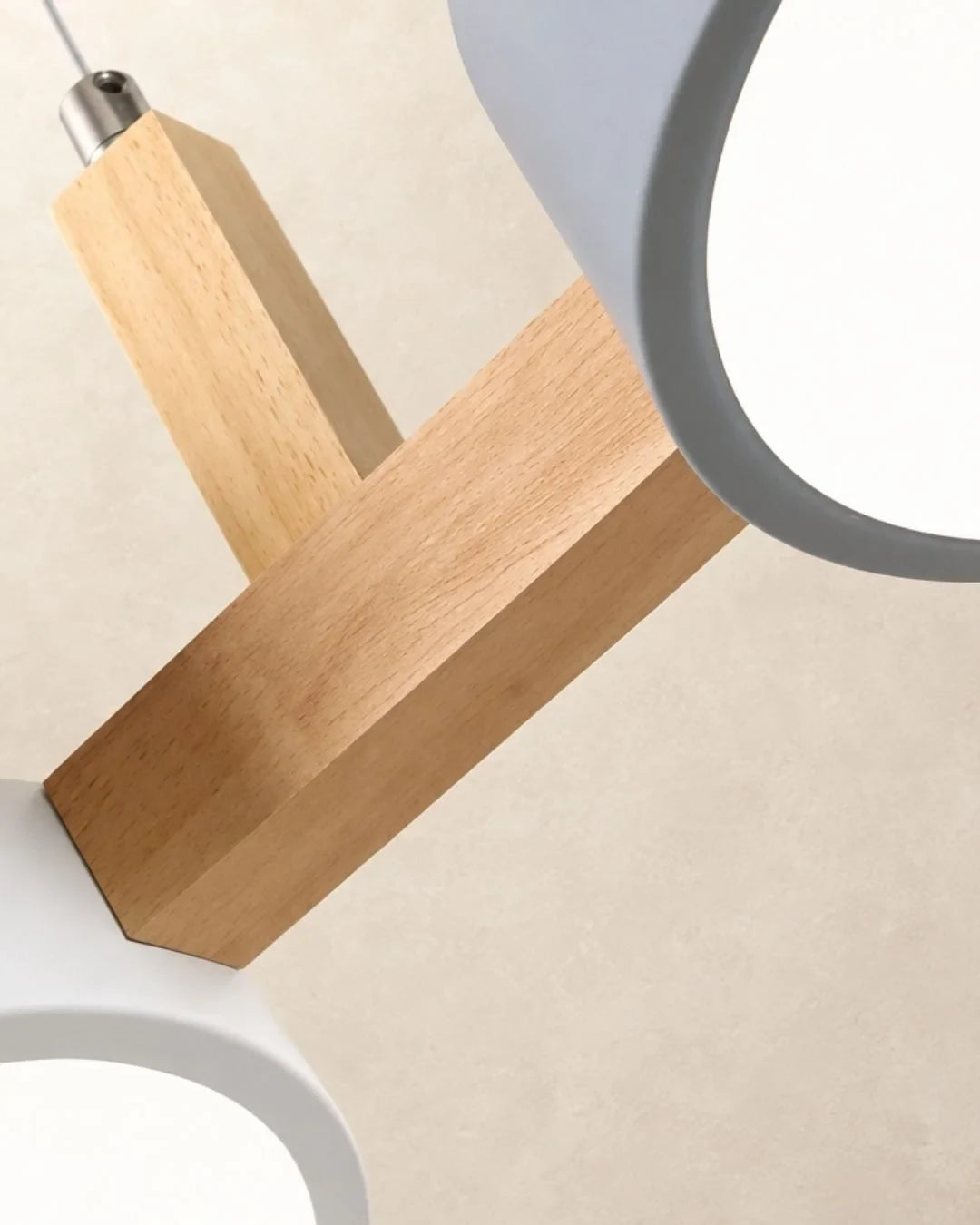 Three-light linear pendant with a wooden bar, close-up of the wooden bar and shades