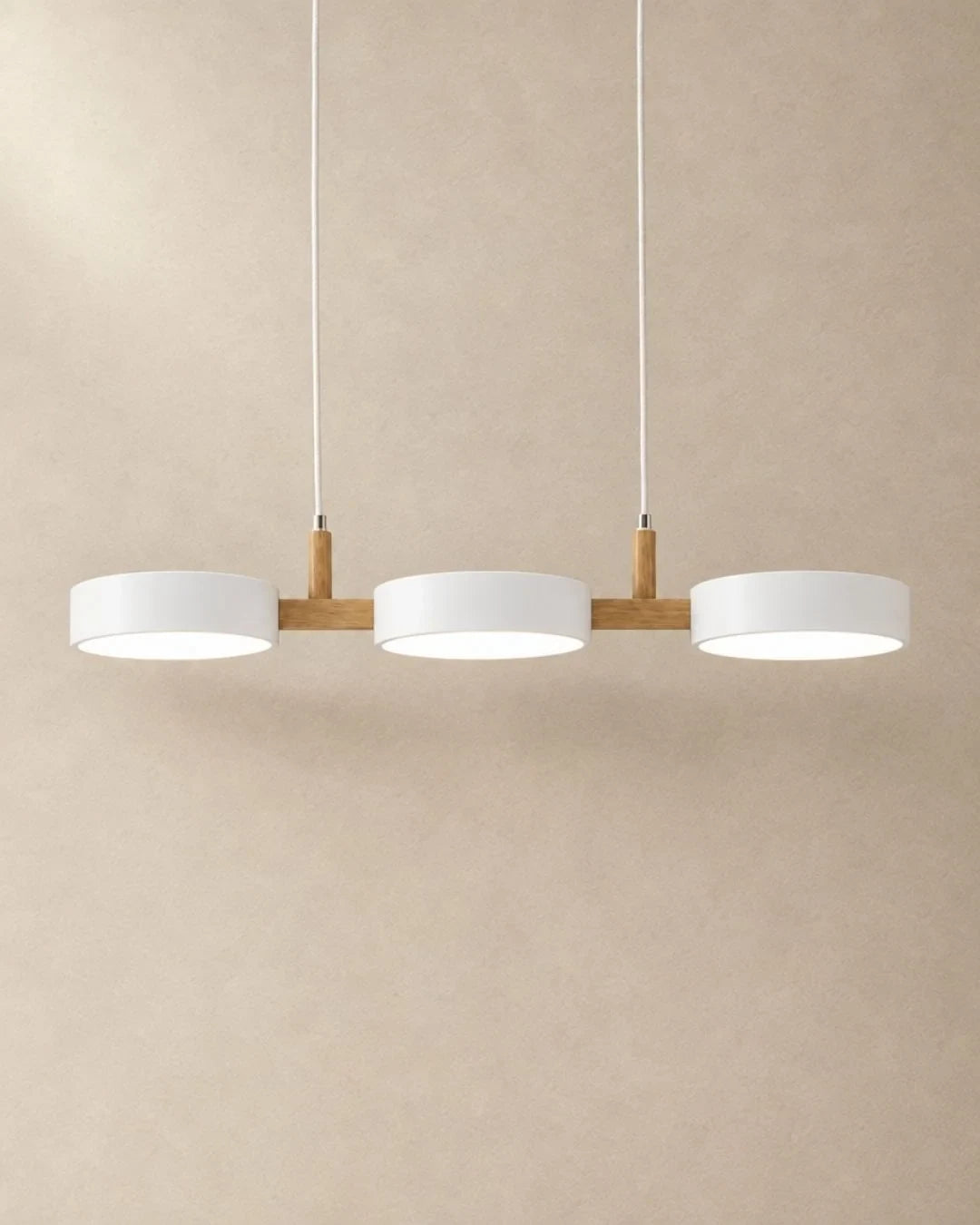 Three-light linear pendant with a wooden bar, with white shades