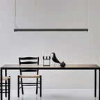 Tilting linear LED pendant, above a dining table