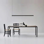 Tilting linear LED pendant, above a dining table