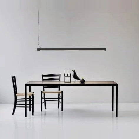 Tilting linear LED pendant, above a dining table