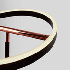Tilting ring LED table lamp, black and copper, close-up of the lit ring